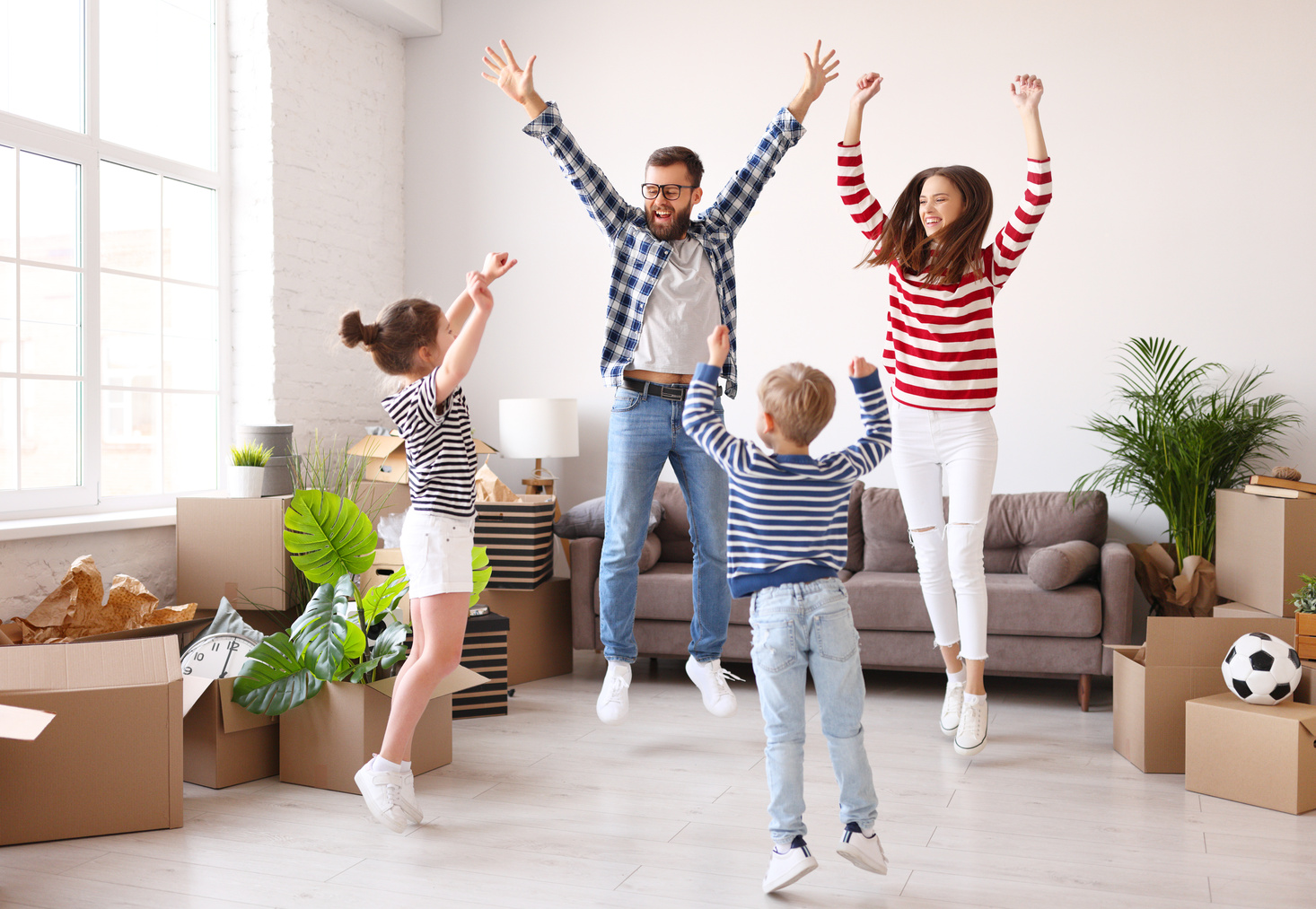 Happy family jumping in new apartment